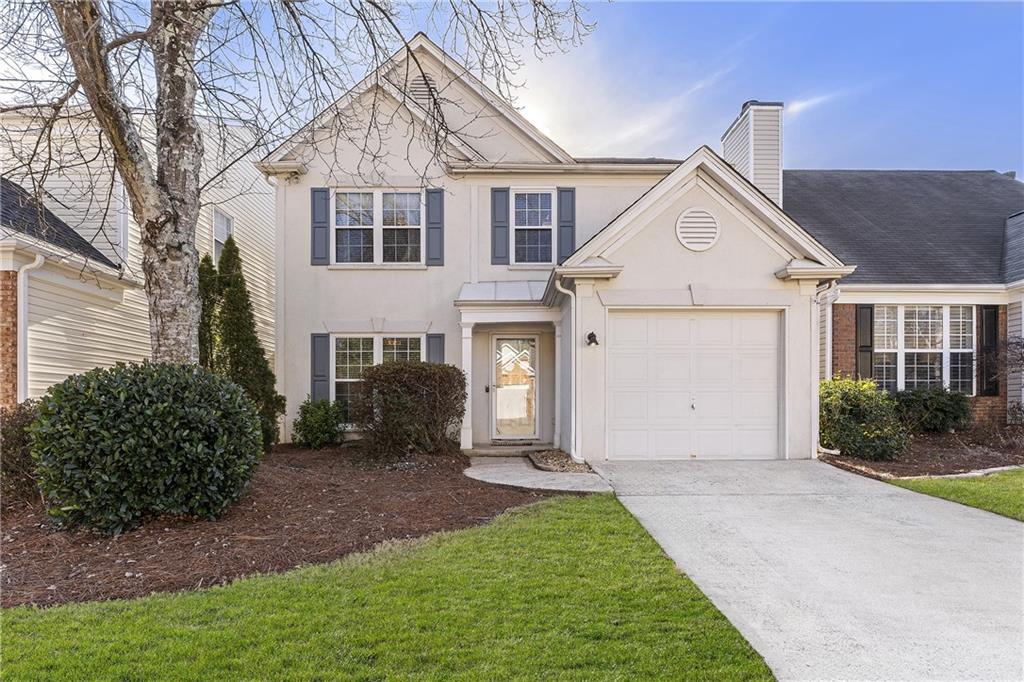 view of front of house with a front yard and a garage