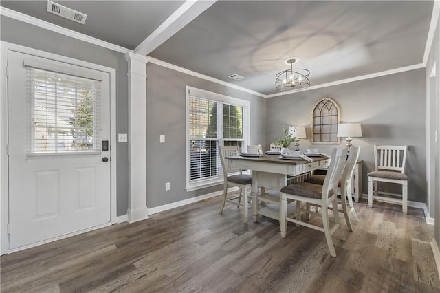 dining area with decorative columns, a notable chandelier, ornamental molding, and dark hardwood / wood-style floors