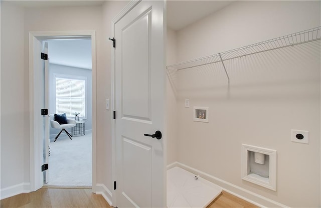 laundry room with baseboards, light wood-type flooring, washer hookup, laundry area, and hookup for an electric dryer