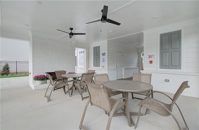 view of patio featuring outdoor dining space, a ceiling fan, and fence