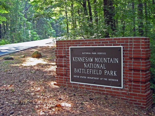 community sign with a view of trees