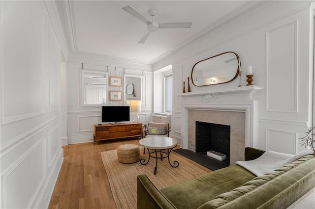 75 Ponce De Leon Ave NE Unit 1006, Atlanta, GA 30308 - living room with a decorative wall, a ceiling fan, ornamental molding, light wood-type flooring, and a fireplace with flush hearth