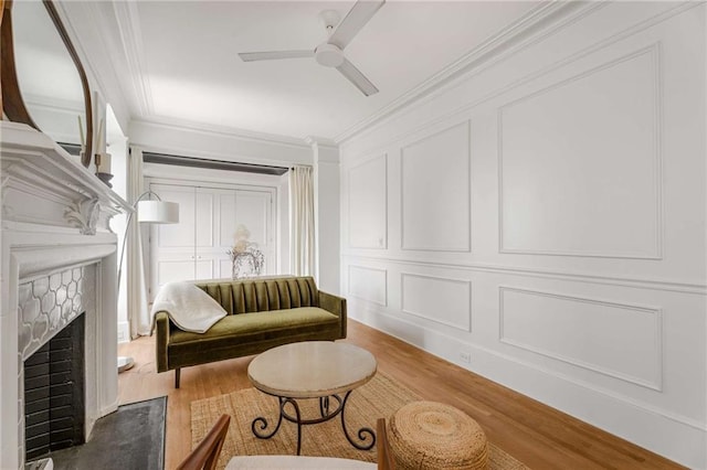 75 Ponce De Leon Ave NE Unit 1006, Atlanta, GA 30308 - living area with a decorative wall, wood finished floors, crown molding, a ceiling fan, and a fireplace