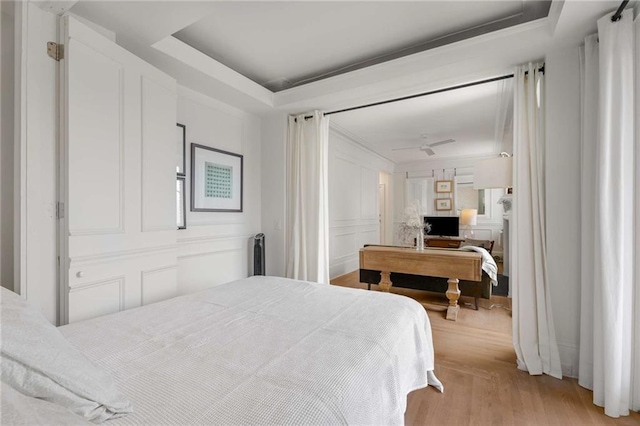 75 Ponce De Leon Ave NE Unit 1006, Atlanta, GA 30308 - bedroom featuring a decorative wall, light wood-type flooring, and a raised ceiling