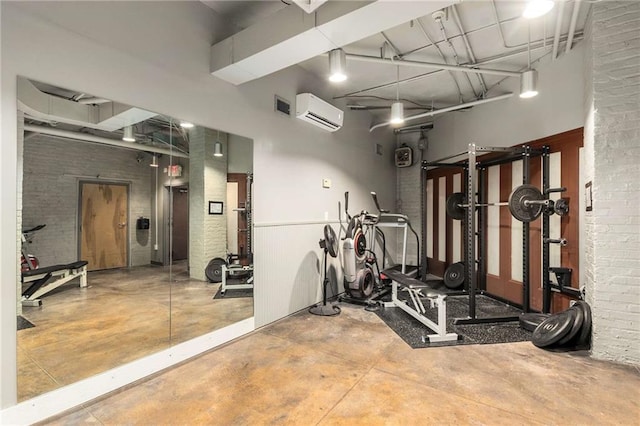 75 Ponce De Leon Ave NE Unit 1006, Atlanta, GA 30308 - exercise room featuring brick wall and a wall mounted AC