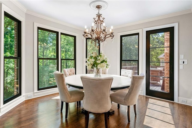 dining space with a chandelier, dark wood finished floors, crown molding, and baseboards