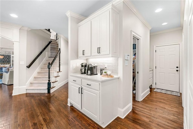 bar featuring baseboards, dark wood-style floors, stairway, ornamental molding, and backsplash