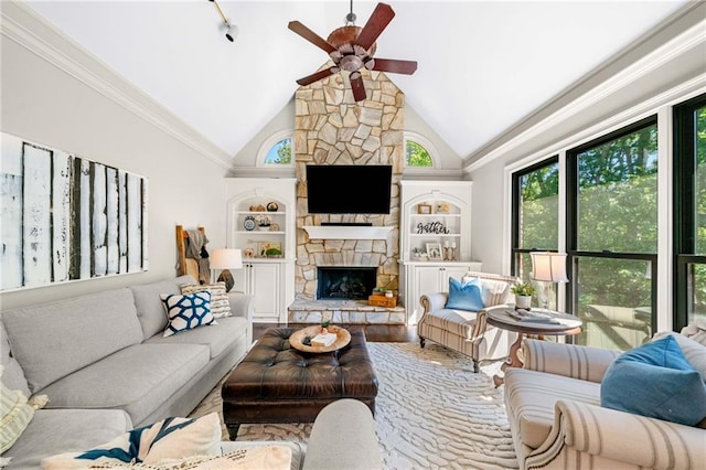 living room with ceiling fan, a stone fireplace, built in features, wood finished floors, and high vaulted ceiling