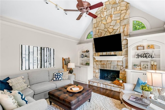 living room featuring a fireplace, high vaulted ceiling, wood finished floors, a ceiling fan, and built in features
