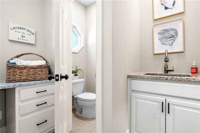 bathroom featuring vanity, toilet, and tile patterned flooring