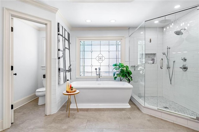 bathroom with a shower stall, toilet, crown molding, a freestanding bath, and recessed lighting