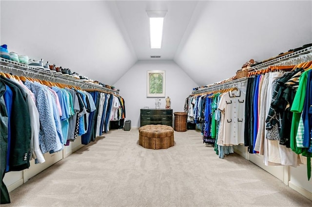spacious closet with carpet flooring and vaulted ceiling