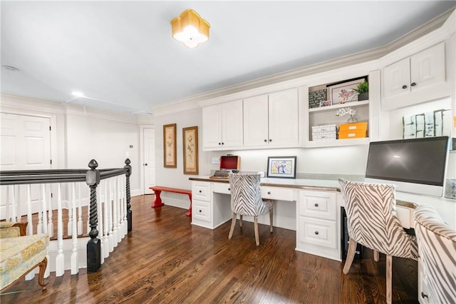 office space with built in study area, dark wood-style flooring, and crown molding