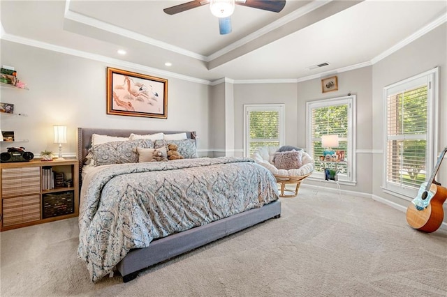 carpeted bedroom with a raised ceiling, multiple windows, ornamental molding, recessed lighting, and baseboards