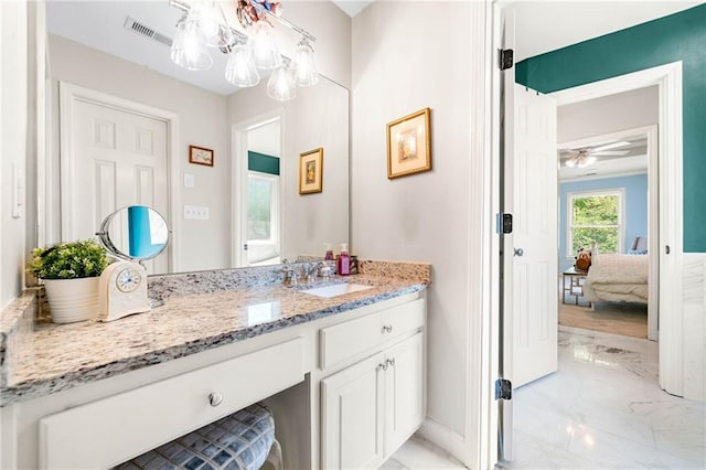 bathroom featuring marble tiled flooring, connected bathroom, vanity, baseboards, and a ceiling fan