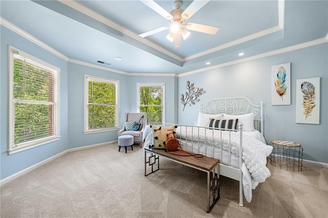 carpeted bedroom featuring ornamental molding, baseboards, a tray ceiling, ceiling fan, and recessed lighting
