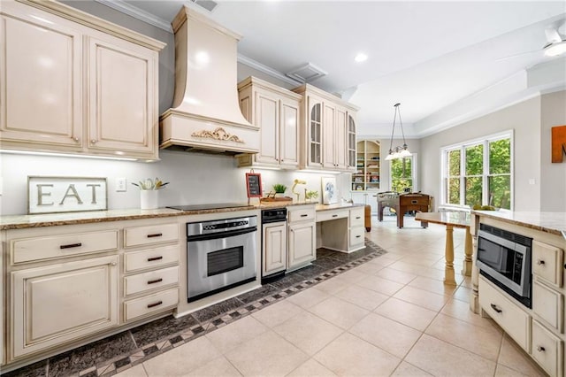 kitchen with stainless steel appliances, cream cabinets, premium range hood, ornamental molding, and recessed lighting