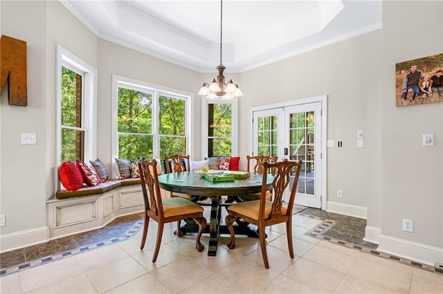 dining room with healthy amount of natural light, a chandelier, french doors, baseboards, and ornamental molding