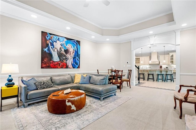 living area with recessed lighting, crown molding, carpet floors, ceiling fan, and arched walkways