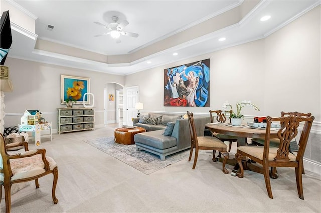 living area featuring arched walkways, carpet floors, crown molding, a ceiling fan, and recessed lighting