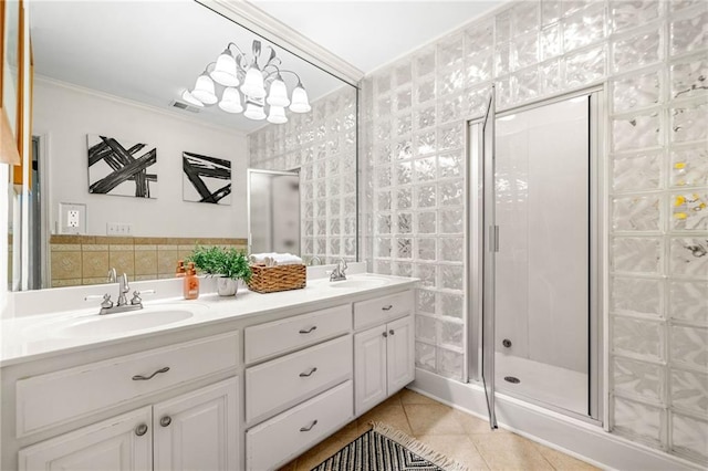 full bath with tile patterned flooring, a shower stall, crown molding, and double vanity