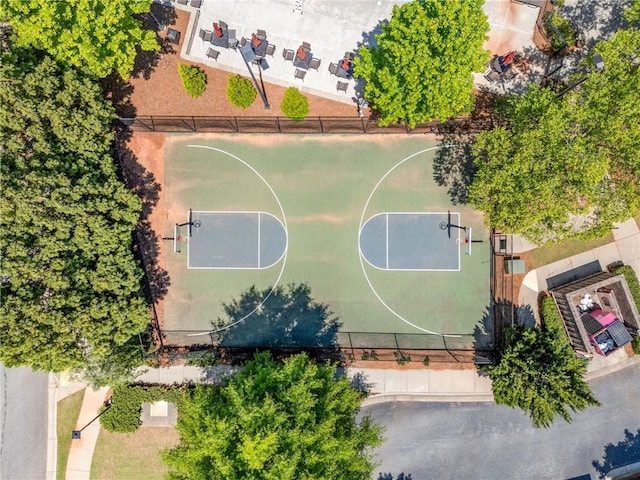 view of basketball court with community basketball court and fence