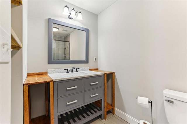 bathroom with baseboards, a shower, toilet, tile patterned floors, and vanity