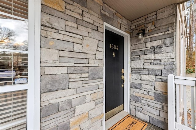 property entrance with stone siding