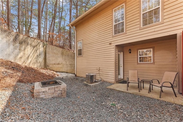 view of side of home featuring cooling unit and a patio