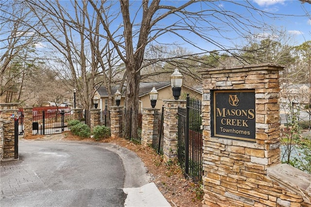 view of street with street lighting, a gate, and a gated entry