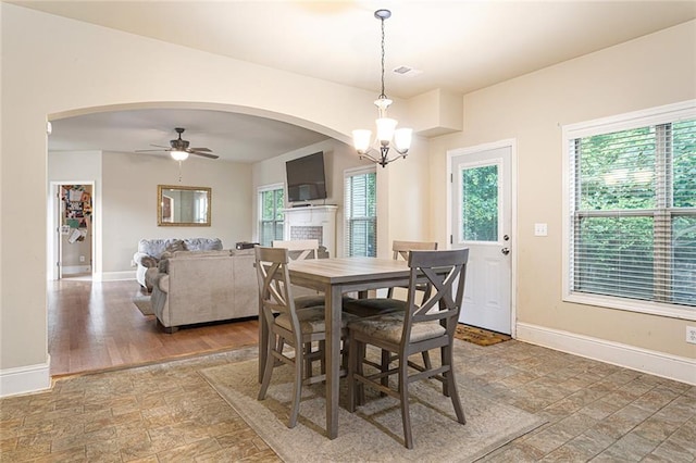 1110 Cureton Dr, Austell, GA 30106 - dining space with baseboards, arched walkways, a ceiling fan, and stone finish flooring
