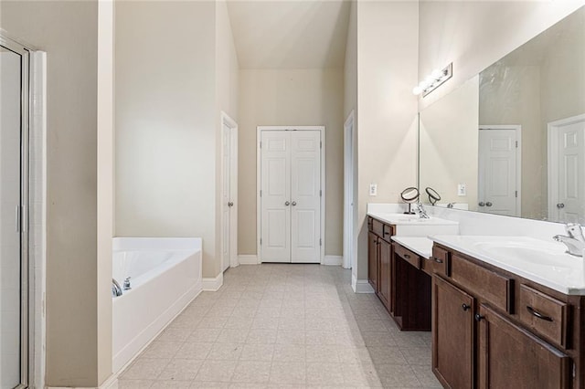 1110 Cureton Dr, Austell, GA 30106 - bathroom with double vanity, a garden tub, baseboards, and an enclosed shower