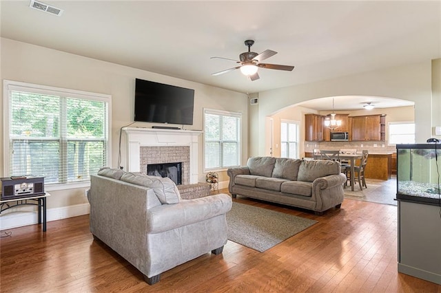 1110 Cureton Dr, Austell, GA 30106 - living room featuring arched walkways, a ceiling fan, hardwood / wood-style flooring, and plenty of natural light