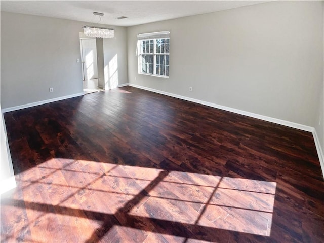 spare room with wood-type flooring