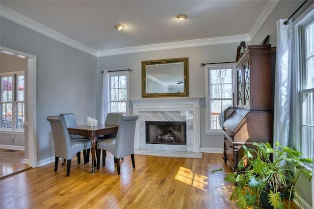 9600 Poplar Ct, Douglasville, GA 30135 - dining room with light wood finished floors, crown molding, baseboards, and a premium fireplace