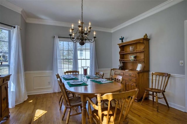 9600 Poplar Ct, Douglasville, GA 30135 - dining area with a chandelier, wood finished floors, wainscoting, crown molding, and a decorative wall