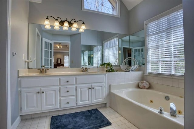 9600 Poplar Ct, Douglasville, GA 30135 - bathroom featuring tile patterned flooring, lofted ceiling, a whirlpool tub, double vanity, and ceiling fan