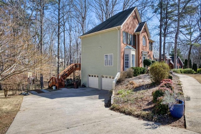 9600 Poplar Ct, Douglasville, GA 30135 - view of side of property with driveway, stairway, and an attached garage