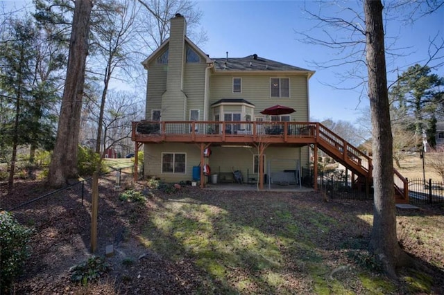 9600 Poplar Ct, Douglasville, GA 30135 - back of property featuring a chimney, a deck, stairs, and a patio area
