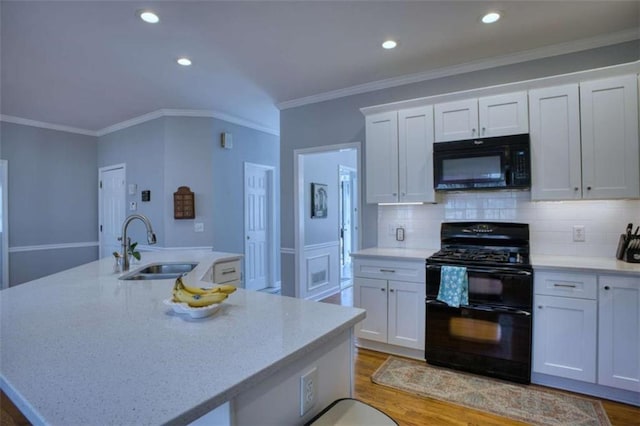 9600 Poplar Ct, Douglasville, GA 30135 - kitchen featuring black appliances, a sink, white cabinets, a large island, and ornamental molding