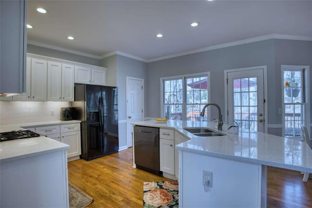 9600 Poplar Ct, Douglasville, GA 30135 - kitchen with dishwasher, black fridge, a sink, stainless steel gas cooktop, and light wood-style floors