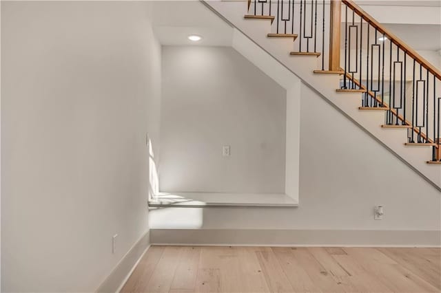 stairway with hardwood / wood-style flooring