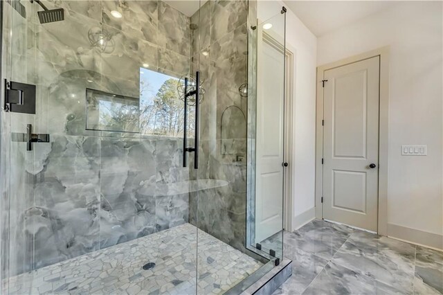 bathroom featuring a shower with door