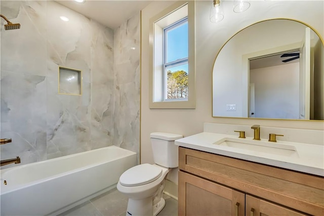 full bathroom with tile patterned flooring, tiled shower / bath, vanity, and toilet