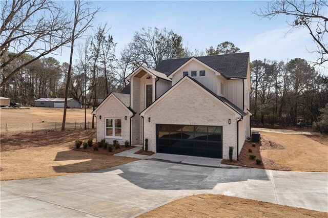 front facade featuring cooling unit and a garage