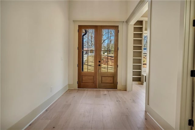 entryway with light hardwood / wood-style flooring and french doors
