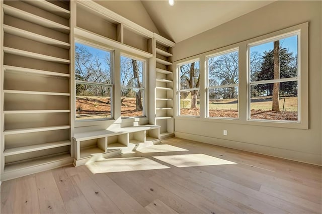 unfurnished sunroom featuring vaulted ceiling