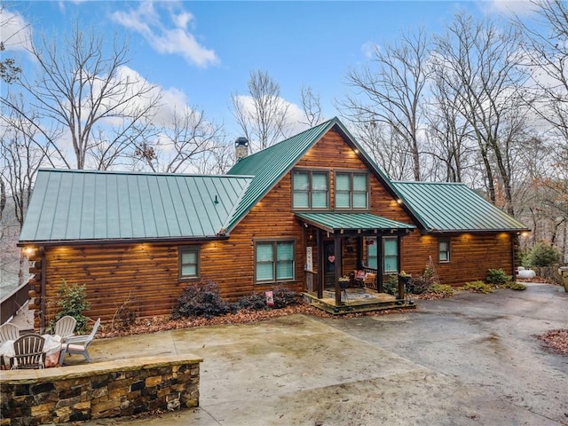 back of house featuring a fire pit and a patio area