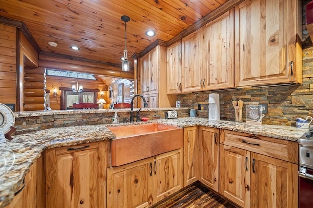 kitchen featuring pendant lighting, sink, rustic walls, light stone counters, and wooden ceiling