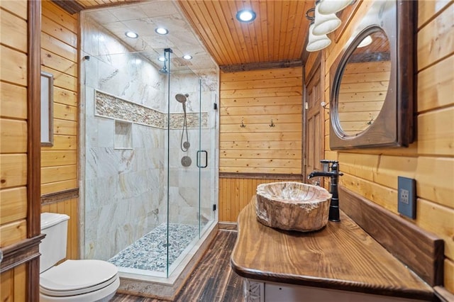 bathroom with toilet, wood ceiling, wooden walls, and a shower with shower door